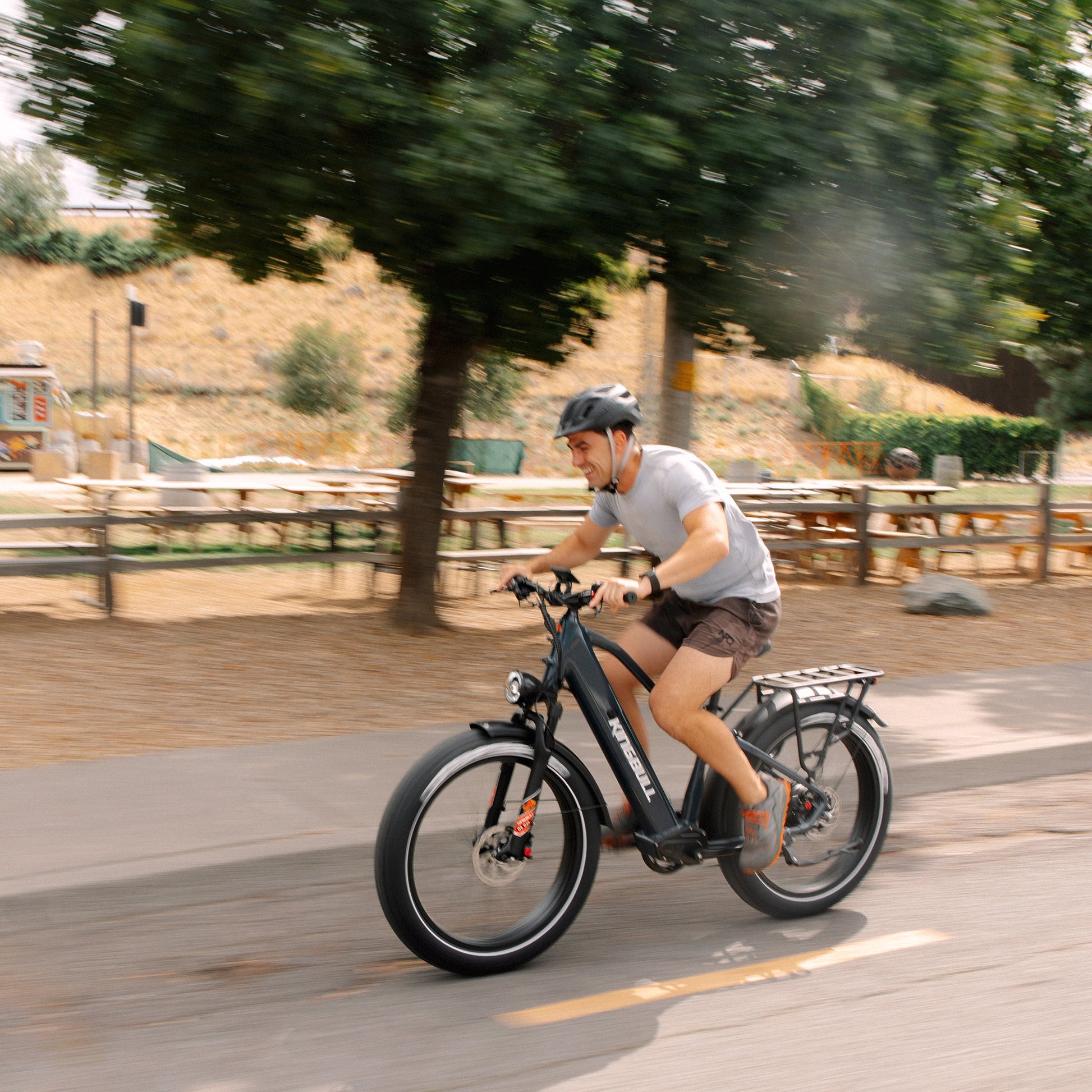 Man happily riding kingbull electric bike Discover 2.0 on the street.