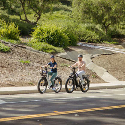 Man and woman riding Kingbull Discover electric bikes together, showing versatile design for all riders