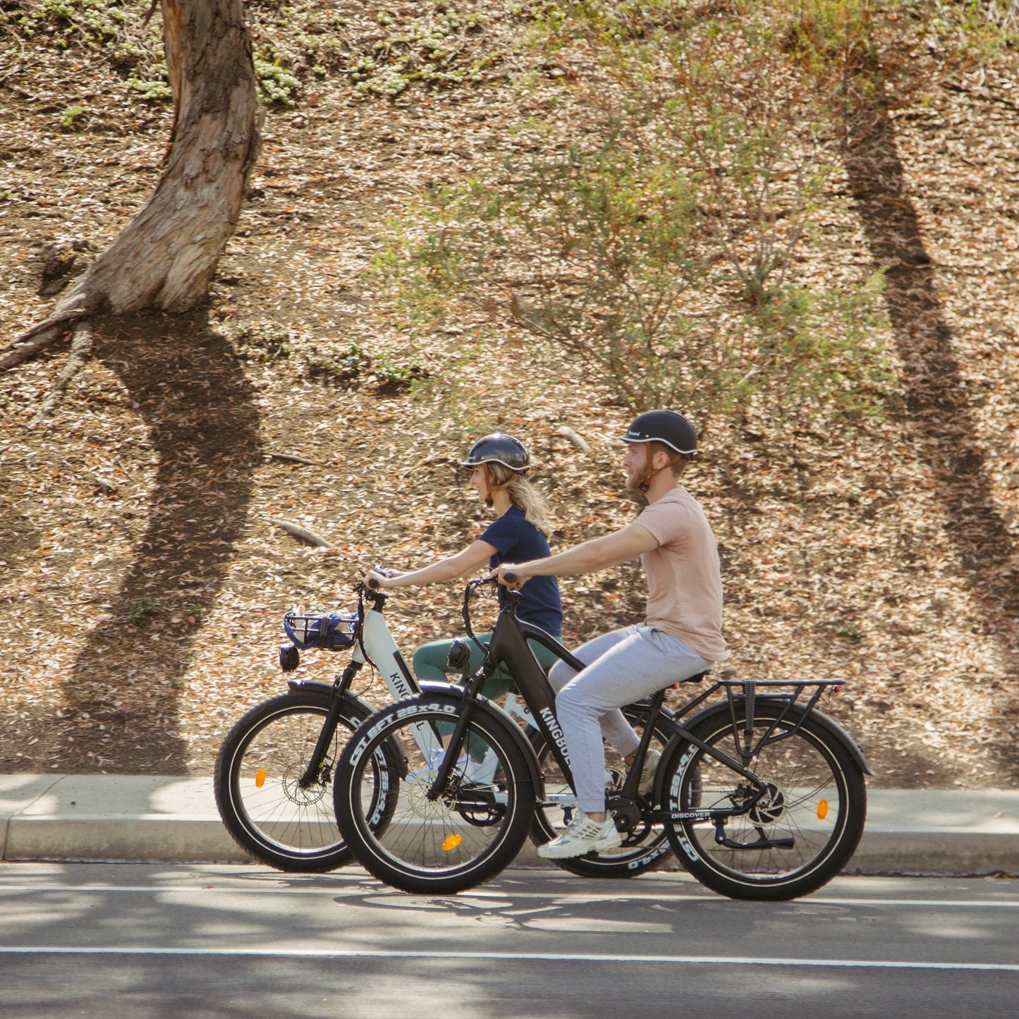 Man and woman riding Kingbull Discover ST electric bikes together, showing versatile design for all riders