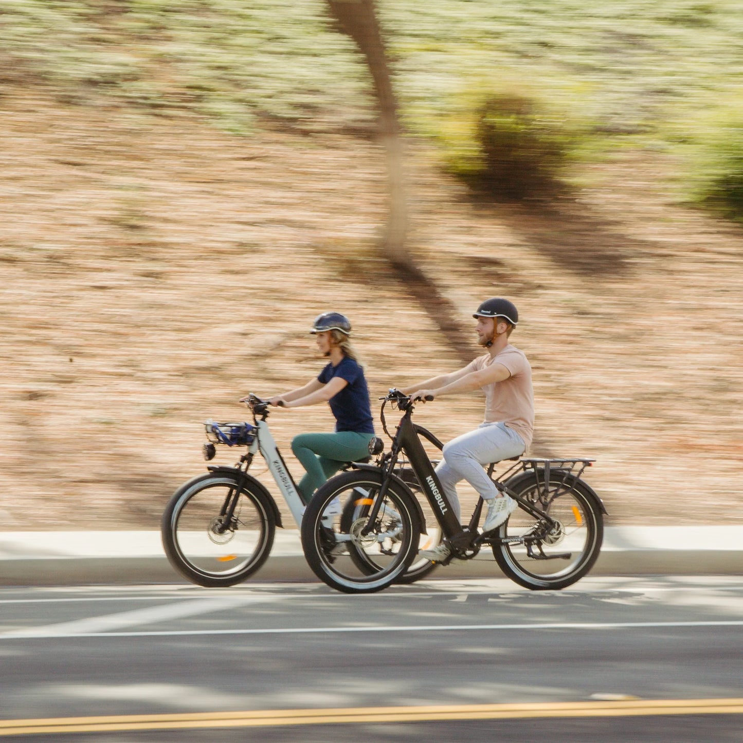 Man and woman riding Kingbull Discover ST electric bikes together, showing versatile design for all riders