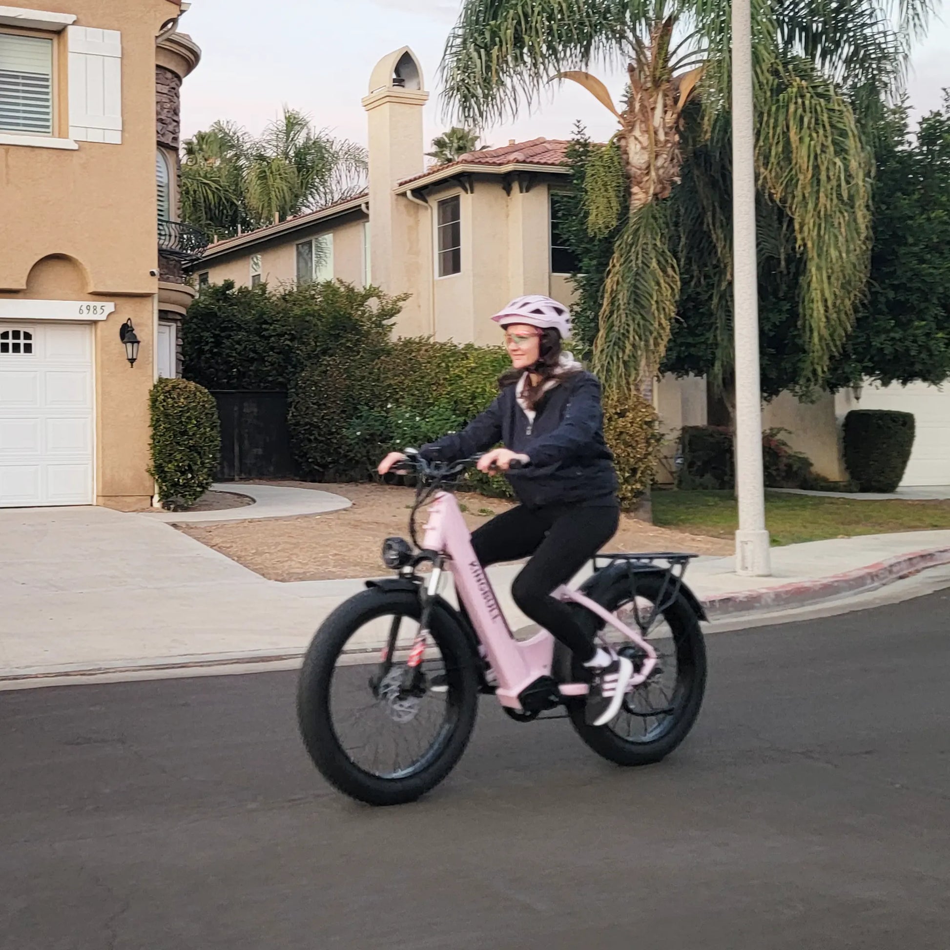 Young woman riding Pink Kingbull Discover ST electric bike, demonstrating comfortable step-through design