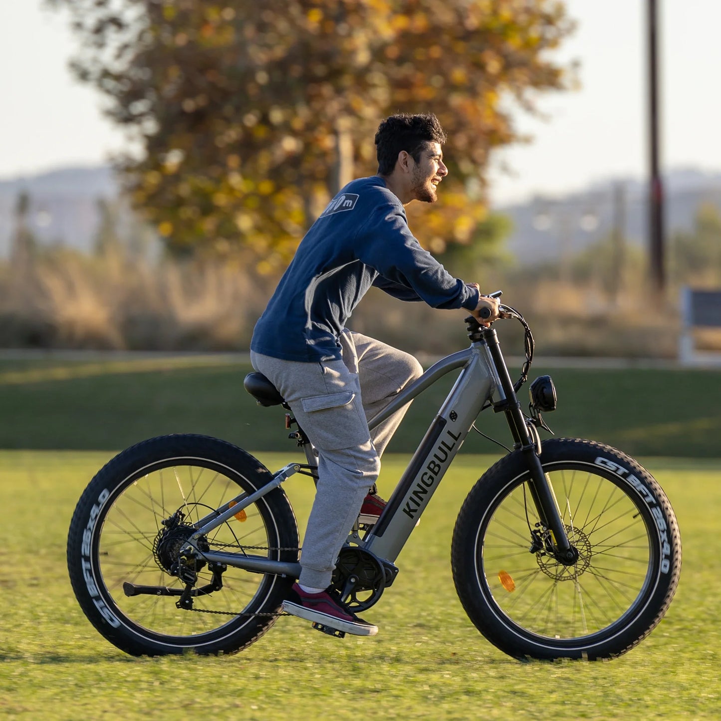 A man riding the Kingbull Rover Ebike on the grass