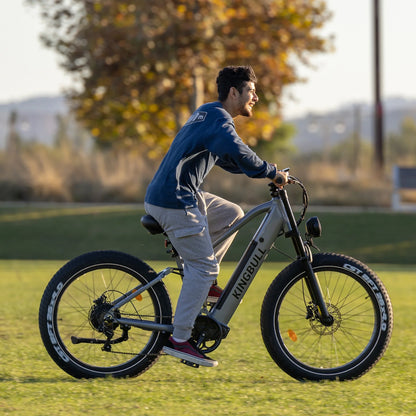 A man riding the Kingbull Rover Ebike on the grass