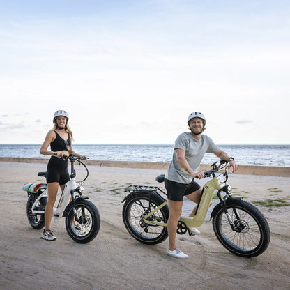 A man and a woman on the beach with their kingbull electric bike